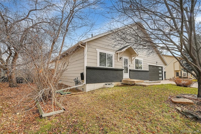 view of front of property with a front yard and a garage