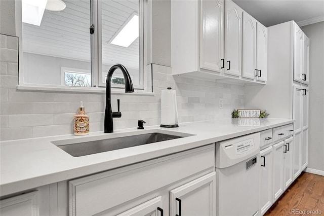 kitchen with dishwasher, dark hardwood / wood-style flooring, white cabinetry, and sink