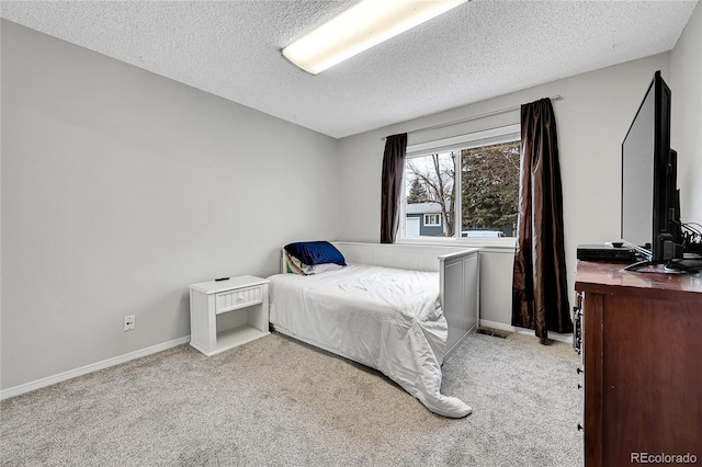 carpeted bedroom with a textured ceiling