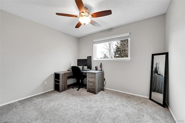 carpeted home office with a textured ceiling and ceiling fan