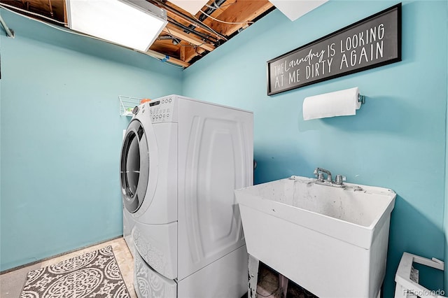 laundry area with washer and clothes dryer and sink