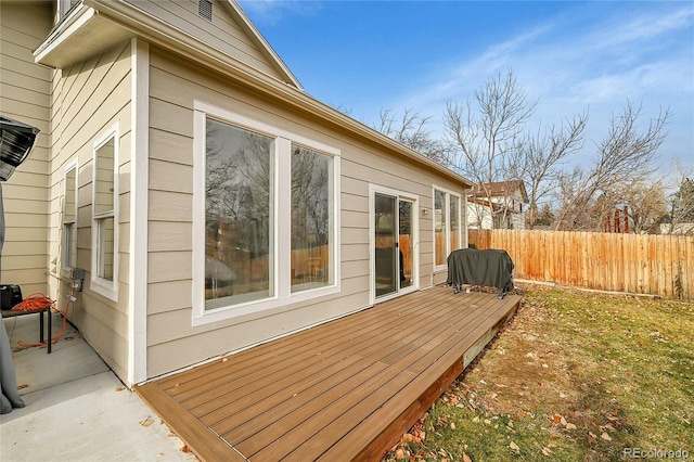 view of side of home with a wooden deck