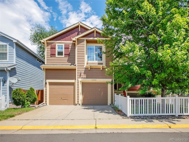 1288 S Beeler Ct, Denver, CO 80247 - view of front of property with board and batten siding, a garage, and driveway