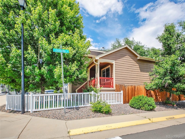 1288 S Beeler Ct, Denver, CO 80247 - view of front of home with a porch and a fenced front yard