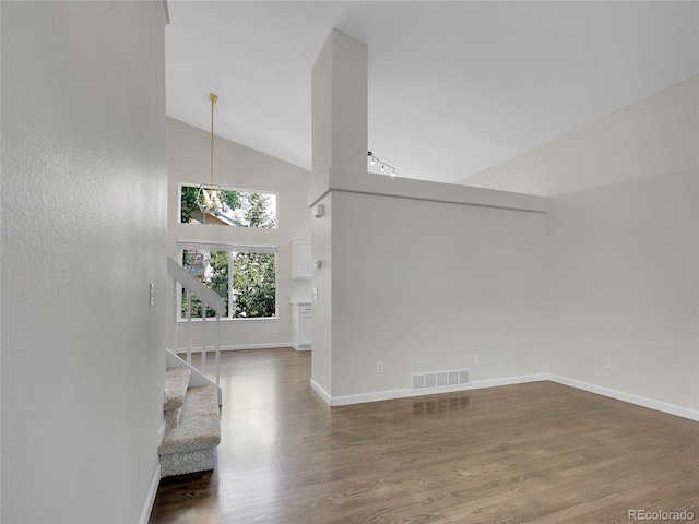 1288 S Beeler Ct, Denver, CO 80247 - unfurnished room featuring high vaulted ceiling, wood finished floors, and stairway