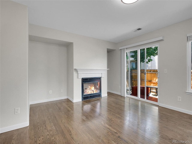 1288 S Beeler Ct, Denver, CO 80247 - unfurnished living room with a glass covered fireplace and wood finished floors