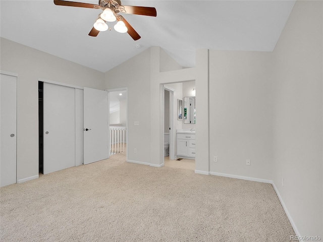 1288 S Beeler Ct, Denver, CO 80247 - unfurnished bedroom with light carpet, multiple closets, vaulted ceiling, ensuite bath, and ceiling fan