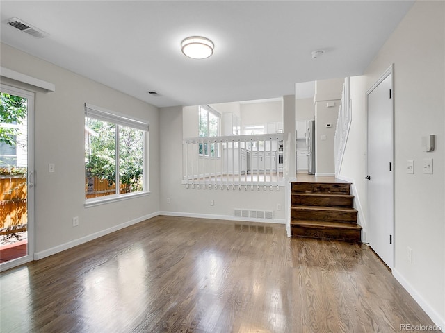 1288 S Beeler Ct, Denver, CO 80247 - unfurnished living room with wood finished floors and stairway