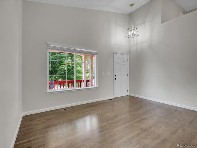 1288 S Beeler Ct, Denver, CO 80247 - entryway featuring a high ceiling, a chandelier, and dark wood finished floors