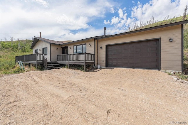 view of front of property featuring a deck and a garage