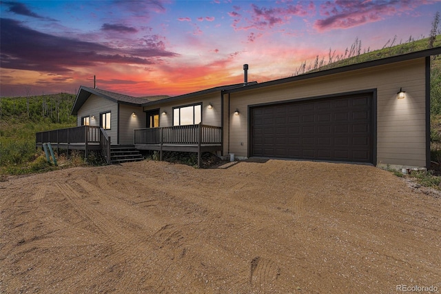 view of front of property featuring a wooden deck and a garage