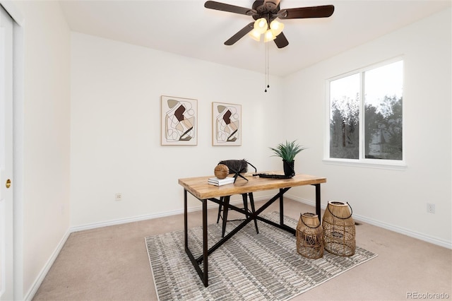 carpeted office space with ceiling fan