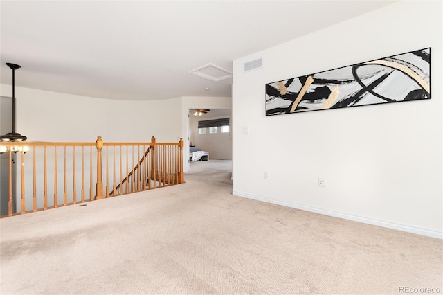 unfurnished room featuring light carpet