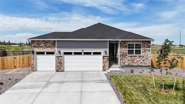 13488 Wabash St, Thornton, CO 80602 - view of front of property featuring stone siding, an attached garage, concrete driveway, and a shingled roof
