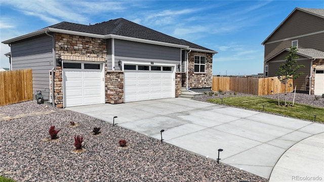 13488 Wabash St, Thornton, CO 80602 - view of front of home with stone siding, driveway, an attached garage, and a shingled roof