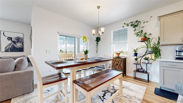 13488 Wabash St, Thornton, CO 80602 - dining area featuring light wood-style flooring and a chandelier