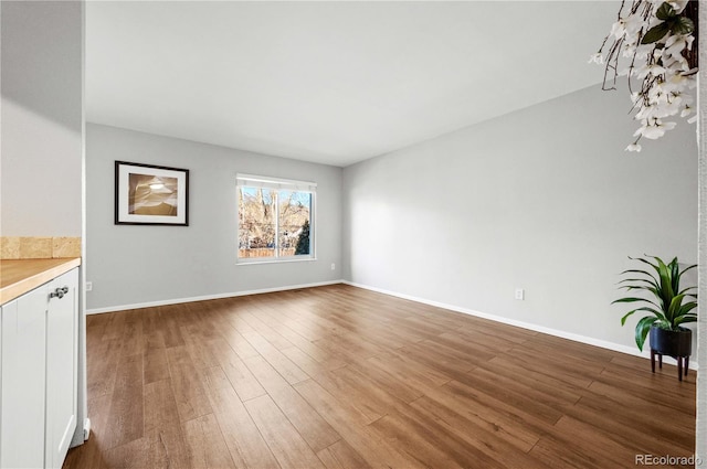 unfurnished living room with dark hardwood / wood-style floors