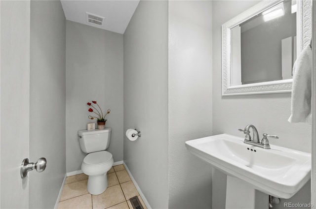 bathroom featuring tile patterned flooring, toilet, and sink