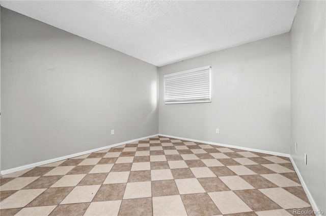 spare room featuring a textured ceiling and vaulted ceiling