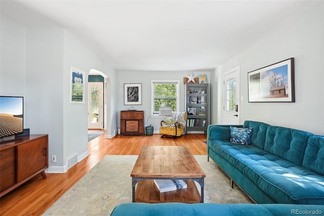 1100 W Mulberry St, Fort Collins, CO 80521 - living room with arched walkways, baseboards, visible vents, and wood finished floors