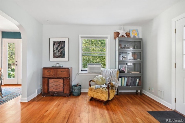 1100 W Mulberry St, Fort Collins, CO 80521 - sitting room with arched walkways, cooling unit, baseboards, and light wood-type flooring