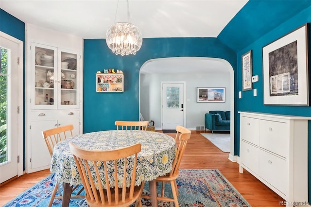 1100 W Mulberry St, Fort Collins, CO 80521 - dining room with an inviting chandelier, arched walkways, light wood-style floors, and visible vents