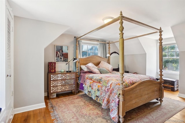 1100 W Mulberry St, Fort Collins, CO 80521 - bedroom with wood finished floors, lofted ceiling, and multiple windows