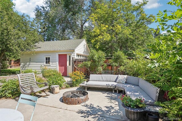 1100 W Mulberry St, Fort Collins, CO 80521 - view of patio / terrace with fence, an outbuilding, and an outdoor fire pit