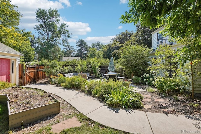 1100 W Mulberry St, Fort Collins, CO 80521 - view of yard featuring a garden, fence, an outdoor living space, a gate, and a patio area