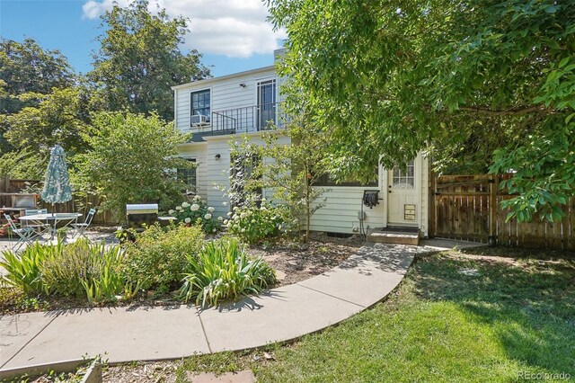 1100 W Mulberry St, Fort Collins, CO 80521 - exterior space featuring a lawn, fence, a balcony, and cooling unit