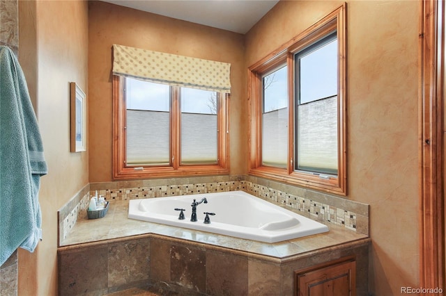 bathroom featuring a relaxing tiled tub