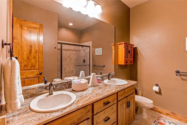 bathroom featuring walk in shower, vanity, toilet, and tile patterned flooring