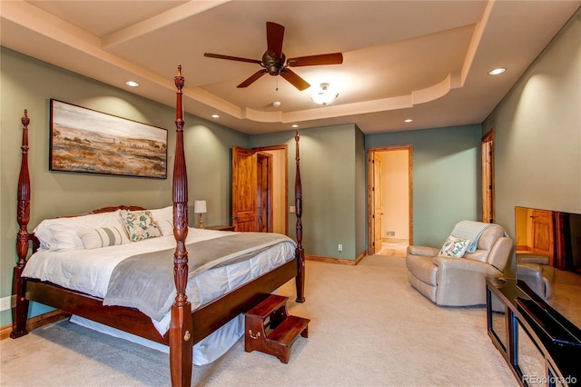 carpeted bedroom featuring a raised ceiling