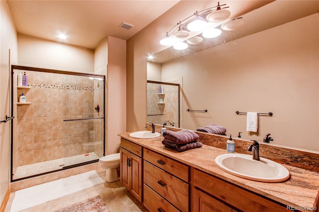 bathroom with vanity, toilet, and an enclosed shower