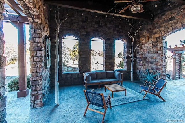 living room with ceiling fan and beamed ceiling