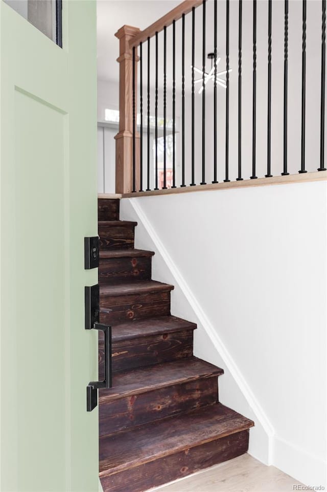 stairway featuring wood finished floors
