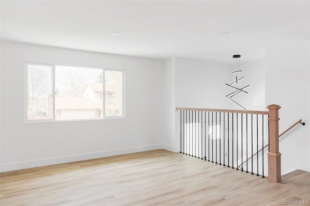spare room with wood finished floors and baseboards