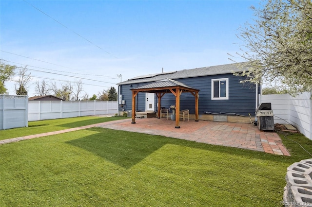 back of house featuring a yard, a gazebo, a patio, and a fenced backyard