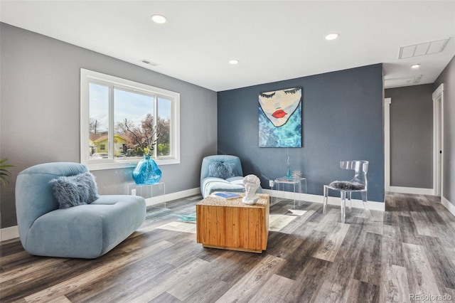 living area featuring dark wood-style flooring, visible vents, and recessed lighting