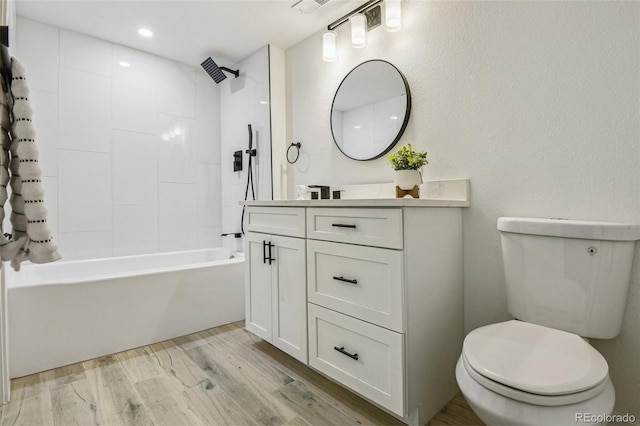 full bath with toilet, shower / bath combination, vanity, and wood finished floors