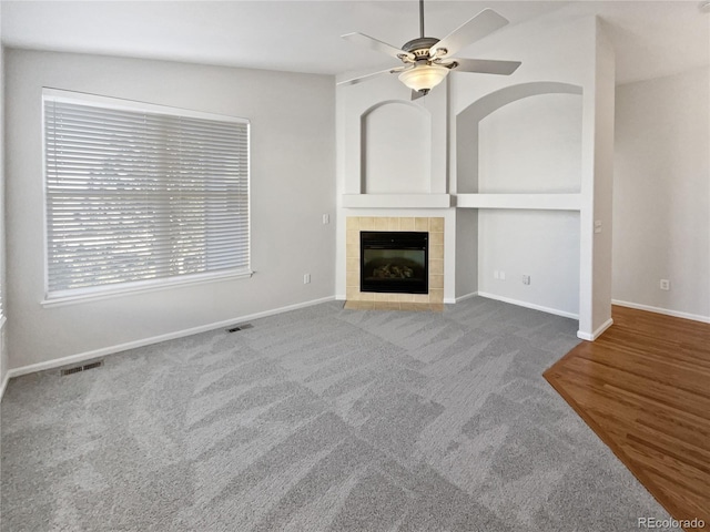 unfurnished living room with a fireplace, carpet, ceiling fan, and lofted ceiling