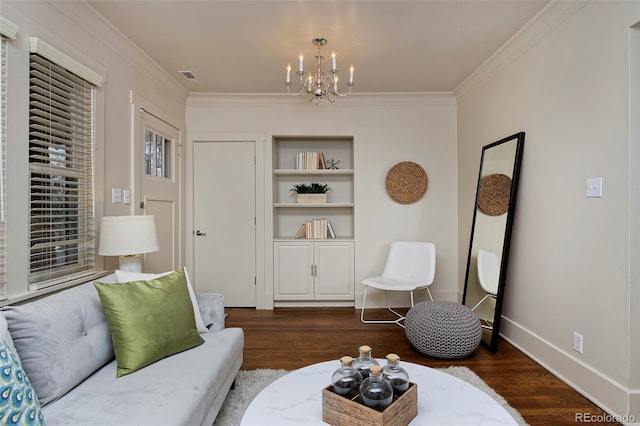 living area with baseboards, ornamental molding, dark wood-style flooring, and an inviting chandelier