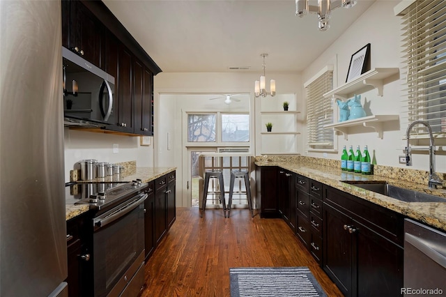 kitchen with dark wood-style floors, open shelves, visible vents, appliances with stainless steel finishes, and a sink