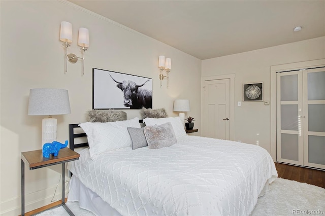 bedroom with baseboards and wood finished floors