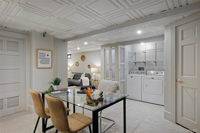 dining room featuring an ornate ceiling, washing machine and dryer, and light carpet