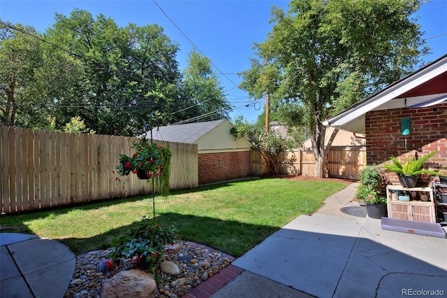 view of yard with a fenced backyard and a patio