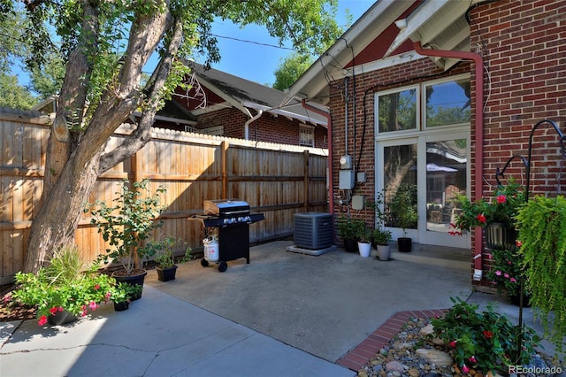 view of patio with fence, a grill, and central air condition unit