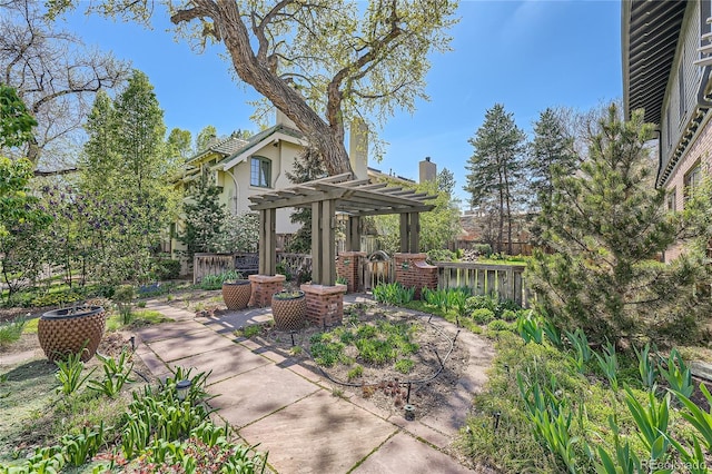 view of patio with a pergola and fence