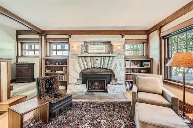 living area with a fireplace and baseboards