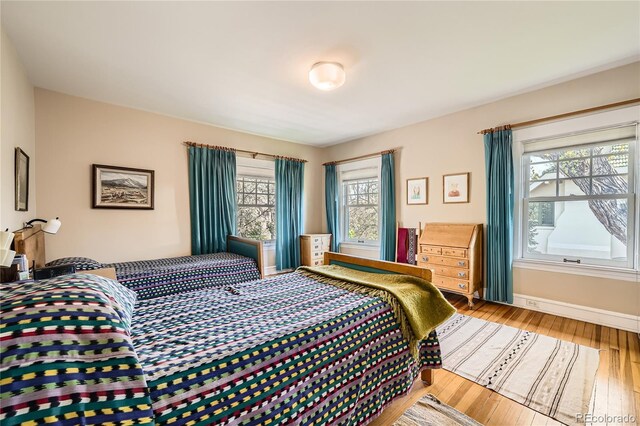 bedroom featuring light wood-style flooring and baseboards